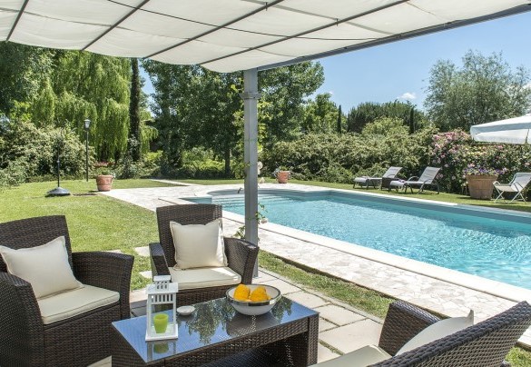 The gazebo set up as a small lounge with armchairs and a coffee table - Albachiara