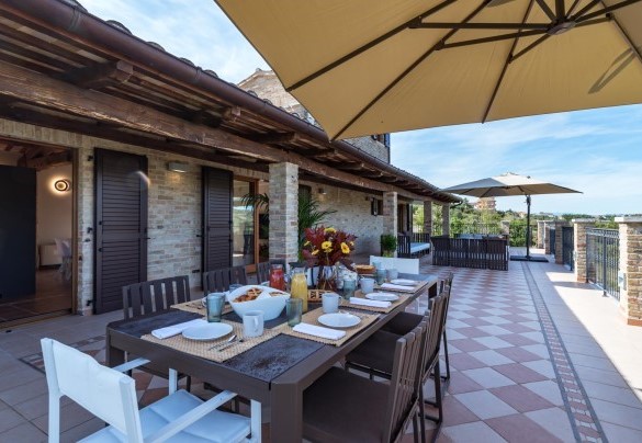 Spacious terrace in front of the living area furnished with table and chairs - Borgo da Monte 