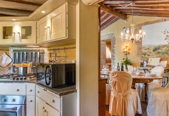 The open-plan living area with lounge, dining room and fitted kitchen (with wood stove and fireplace ornamental) – Borgo Paradiso