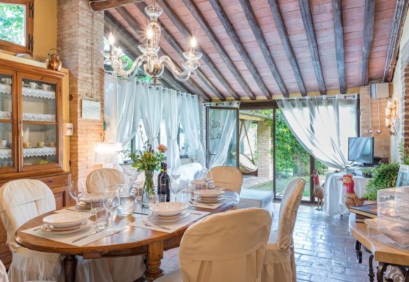 The entrance opens directly into the open-plan living area with lounge and dining room – Borgo Paradiso