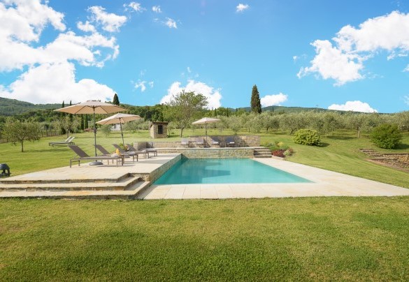 The swimming pool lies in an area of the garden reached up five steps and across the lawn surrounding it – Ca Maggiore