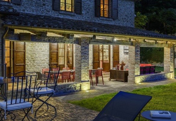 Detail of the stone facade and lit porch - Ca Seppe