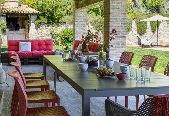 Porch with set dining table and colorful lounge area - Ca Seppe