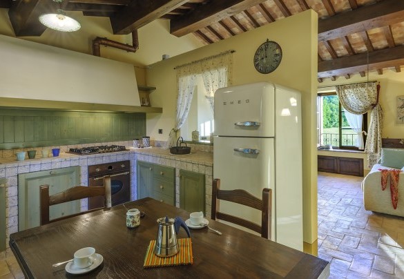 Kitchen with stone walls, wooden cabinets and vintage fridge - Ca Seppe