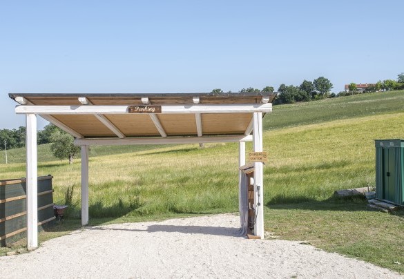 The pergola is equipped with photovoltaic panels, destined to the parking and charging of electric cars and e-bikes – Casa Pilar