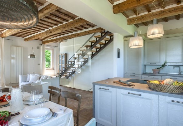 Open space kitchen with living area and staircase leading to the second floor – Casa Pilar