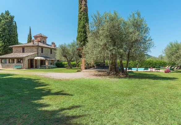 In the centre of the garden towers the austere stone structure - Casa Torrione 
