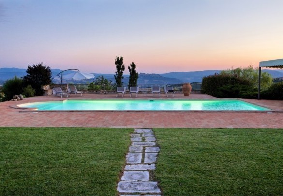 The beautiful swimming pool lit up at night - Casal del Salice