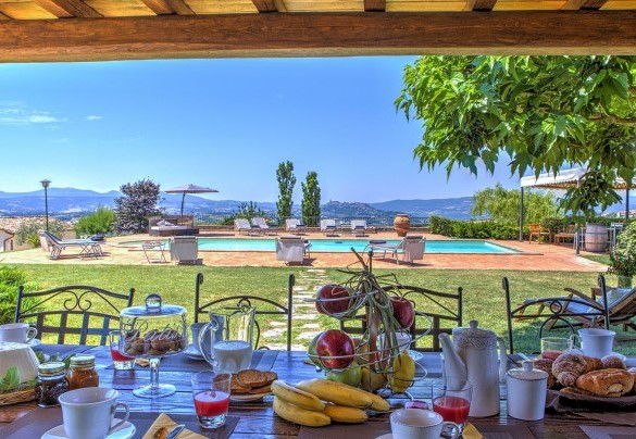 Outside the French window of the house is a portico  furnished with chairs and table - Casal del Salice 