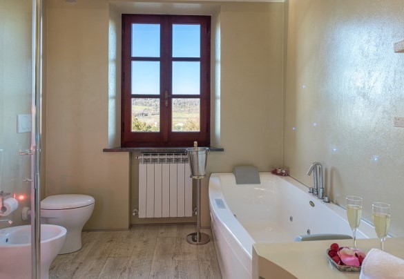 The characteristic bathroom with a whirlpool tub and shower - Casale Bella Vita