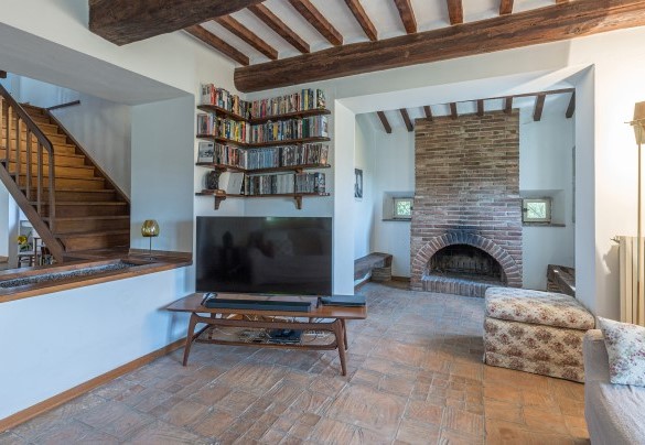 Il salotto con Smart TV, caminetto ornamentale e scala per il primo piano - Casale Le Querce di Cetona