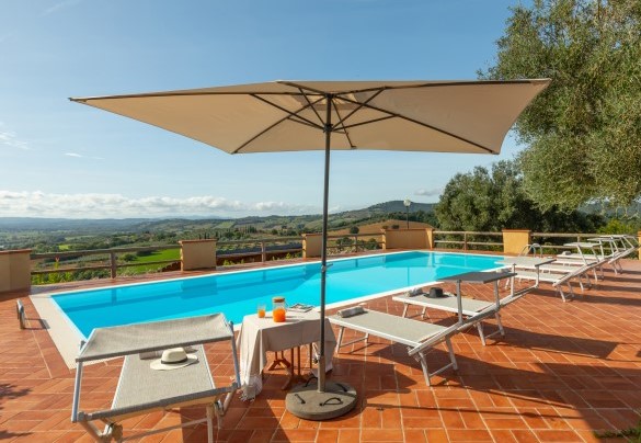 The terracotta pool terrace, furnished with sunbeds, sun umbrella and cold shower - Casale Ombrone
