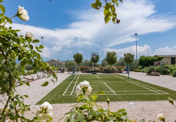 The badminton court and in the background the glass greenhouse - Casale Santa Lucia   