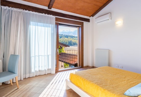 The first-floor master bedroom overlooking the courtyard - Cascina La Valle