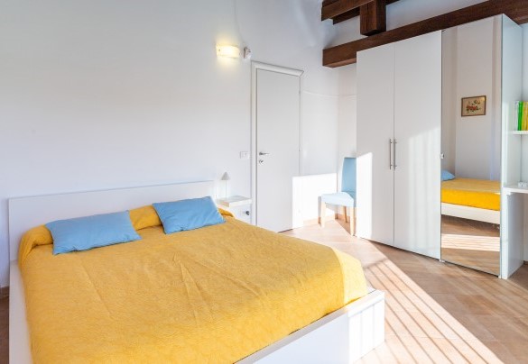 The first-floor master bedroom overlooking the courtyard - Cascina La Valle