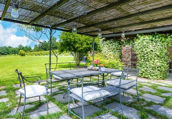 A beautiful gazebo equipped dining area is located right in front of the exit of the kitchen - Cascina Moglia