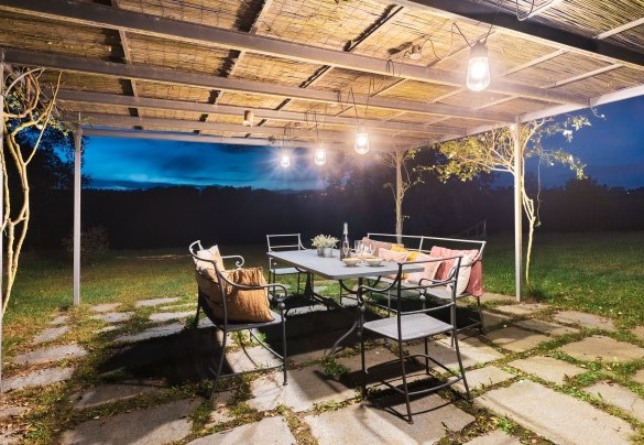 A beautiful gazebo equipped dining area is located right in front of the exit of the kitchen - Cascina Moglia
