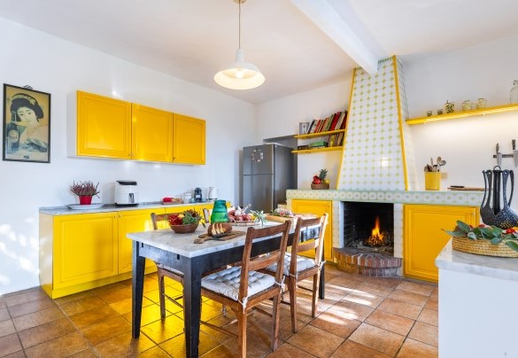 The generously sized kitchen with its French window leading to the pergola – Cascina Monferrato