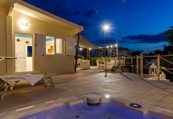 Zona solarium con lettini e vasca idromassaggio – Casetta del Pescatore