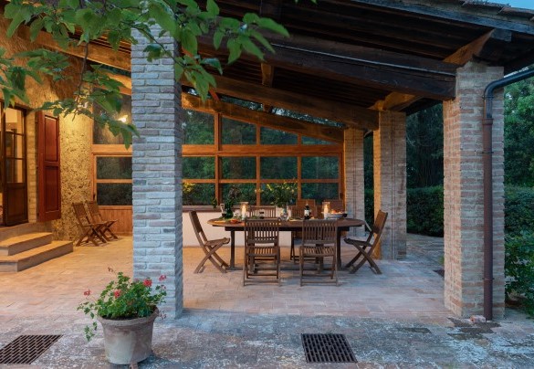 The outdoor areas include a cosy dining area on the terracotta-paved patio - Cosciano