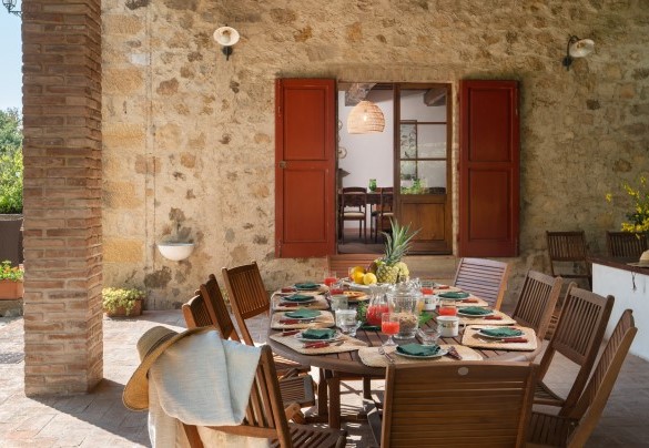 On the covered, tiled patio is the outdoor dining area, connected to the dining room inside the villa - Cosciano