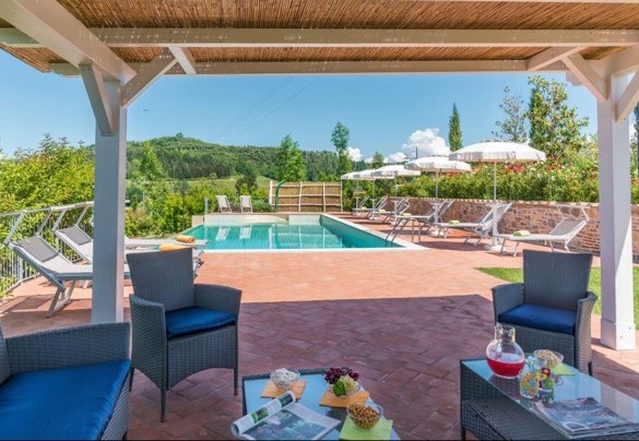 Il gazebo di legno con tavolo e poltroncine nella zona solarium – Dimora San Jacopo