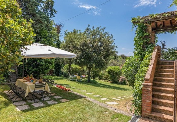 The external stone staircase to go to the loggia of the Farmhouse + the outside table and umbrella toe at all together