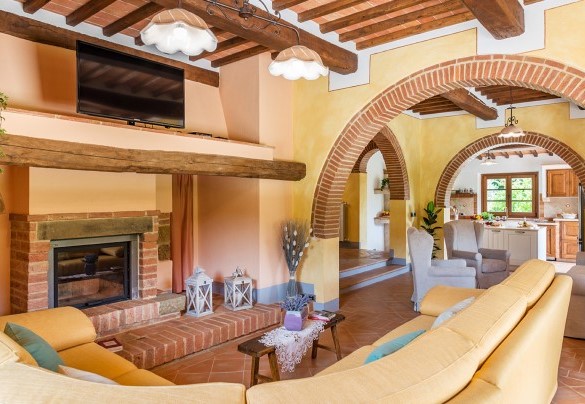 living room on the ground floor with a fireplace and TV - Il Casale Di Manuele