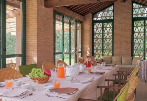 The veranda, created in the old barn, is perfect for outdoor dining – Il Cerreto