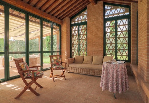 The veranda enclosed with windows, designed to be the perfect outdoor dining area – Il Cerreto