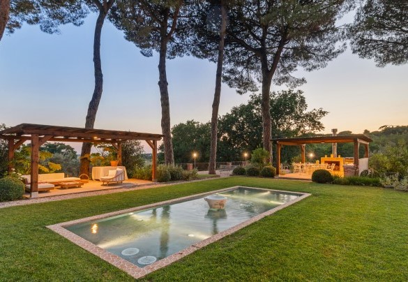Le luci del tramonto avvolgono il giardino sul retro della casa attrezzato con I due gazebo in legno ed abbellito dalla fontana - Antico Ceraso