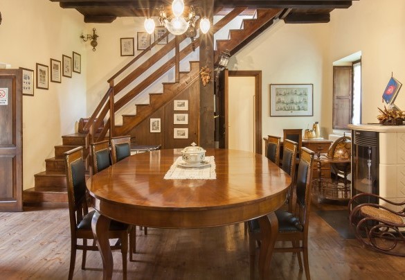 Table with chairs and connecting stairs  between the two floors	- Il Giardino di Sibilla