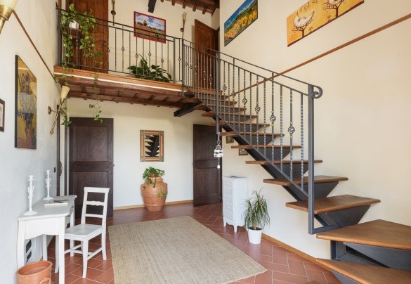 A staircase in the hallway leads up to the first floor – L’Ovile