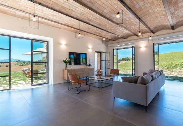 The modern living room and dining room with various connections to the outside - La Buona Maniera
