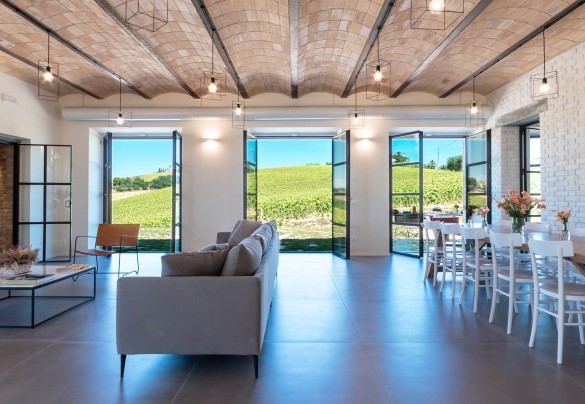 The modern living room and dining room with various connections to the outside - La Buona Maniera