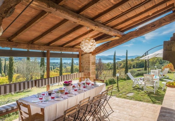 The porch in the pool area shades the table prepared for outdoor breakfasts - La Martinella 12