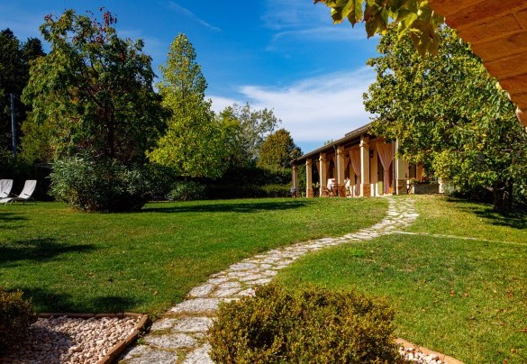 Well-kept garden full of flower beds, flowering plants and bushes of Mediterranean herbs – La Tana del Ghiro