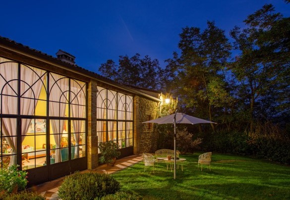 The brightly-lit veranda characterized by expansive glass walls – La Tana del Ghiro