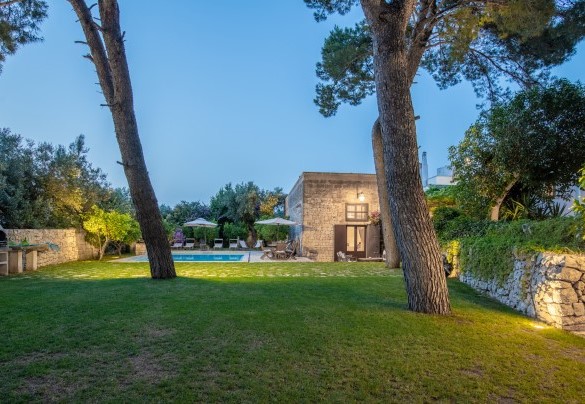 Manicured lawn surrounded by tall old trees – Masseria Tarsia Incuria
