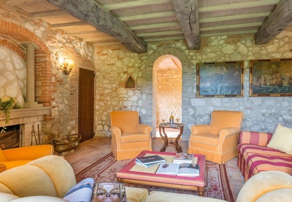 The living room with a fireplace maintains the stone exterior style - Monticchia