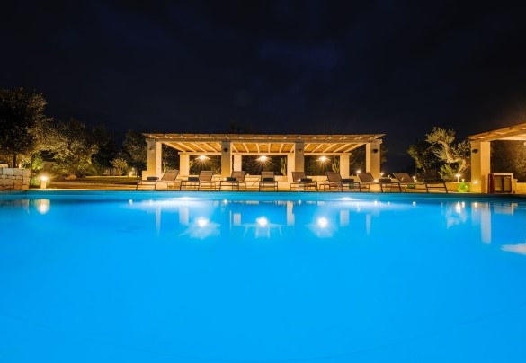 Spectacular swimming pool is surrounded by dry stone walls and framed by the lush garden - Opuntia Trulli e Lamie