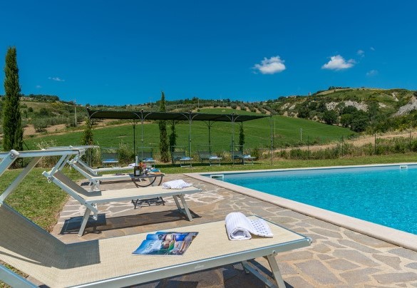 La zona solarium si sviluppa attorno la piscina - Podere Collelungo