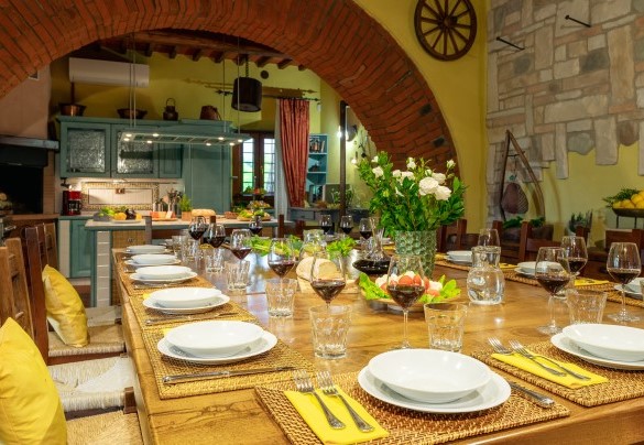The large open-plan area with double kitchen on ground floor of the main building - Podere Giardino