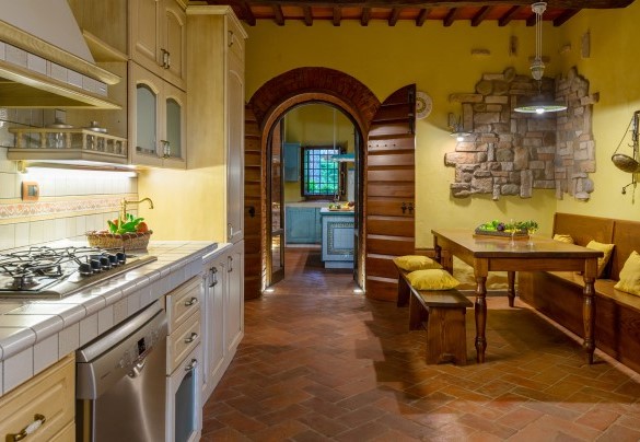 The large open-plan area with double kitchen on ground floor of the main building - Podere Giardino