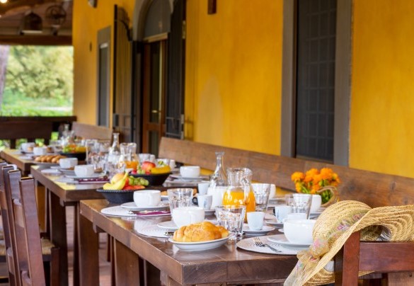 The main kitchen leads directly out onto the large outdoor portico equipped with dining area – Podere Giardino