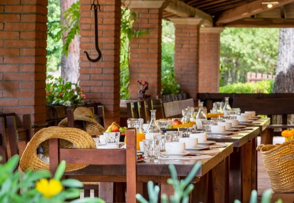 The main kitchen leads directly out onto the large outdoor portico equipped with dining area - Podere Giardino