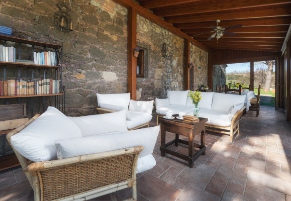 Beautiful, glass-enclosed veranda with a nice dining table and sitting area 