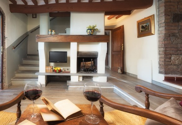 Small sitting room with fireplace and TV with internal staircase leading up to the first floor – Podere Il Chiesino