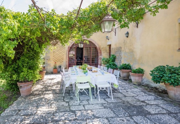 Il grande tavolo da pranzo ombreggiato da piante rampicanti - Podere Pratovecchio
