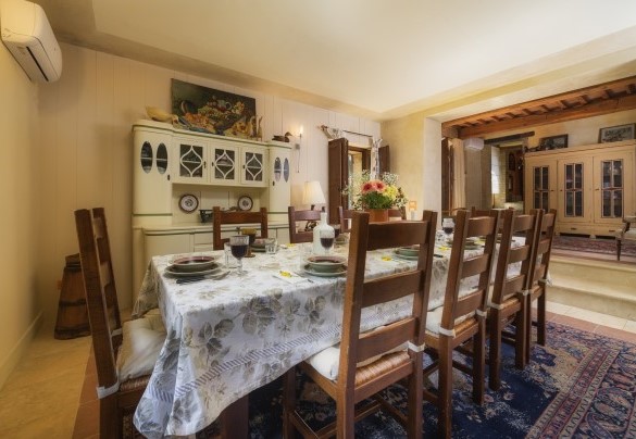 The dining room with access to the external dining area and internal stairs – Podere Santa Croce